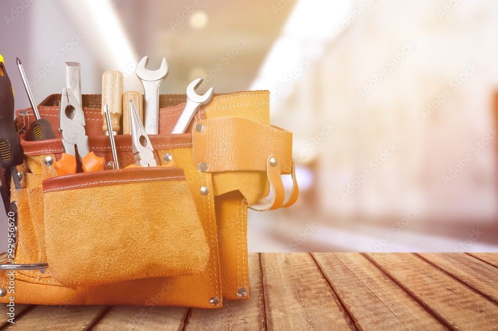 Poster tool belt with tools on wooden background