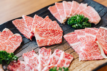 Close-up Premium Rare Slices many parts of Wagyu A5 beef with high-marbled texture on stone plate...