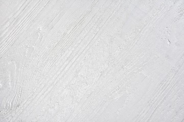 White wooden background with textured surface and selective focus. Empty wooden backdrop. Timber surface with rough structure. White background. Plank gray desk with empty space for image or text