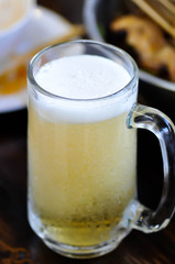 a glass of beer with beer foam