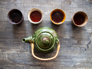 Teapot and cups (bowls) with fragrant hot tea