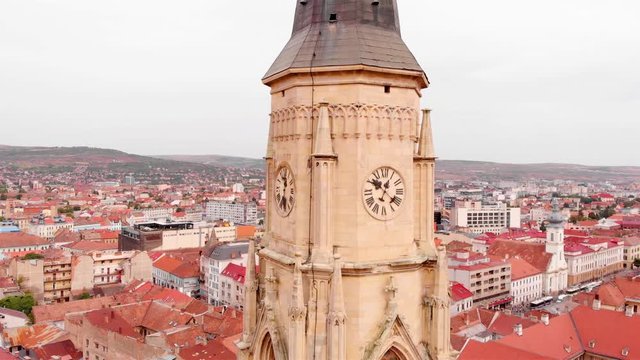 Aerial footage Close to Large Church Tower Clock  in Europe Drone view of Cluj, in the heart of Transylvania, Romania. church medieval tower 