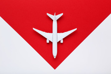 Airplane model on red paper background