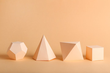 Paper geometric figures on beige background