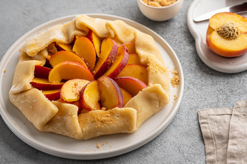 Appetite summer peach galeta on white table with copy space. summer open tart photo for cook book or food blog.