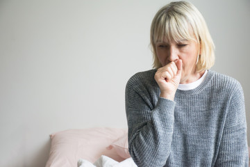 Senior woman is sick, sore throat,cough isolated on white background.Sick woman with sore throat and having cough. 