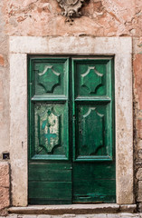 Green medieval door in old town.