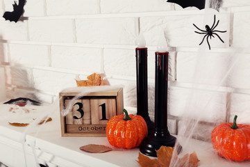 Wooden calendar with orange pumpkins, lamps and dry leafs - Powered by Adobe