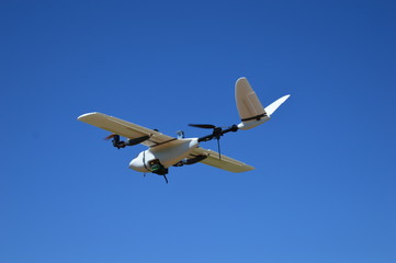Fototapeta na wymiar Hybrid drone flying in a cloudless day of blue sky