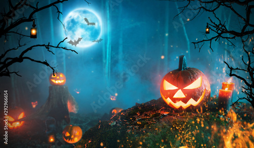 Spooky halloween pumpkins in dark forest