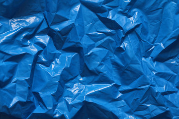 Blue plastic bag texture background. Waste recycling concept. Crumpled polyethylene and cellophane. Reuse materials.