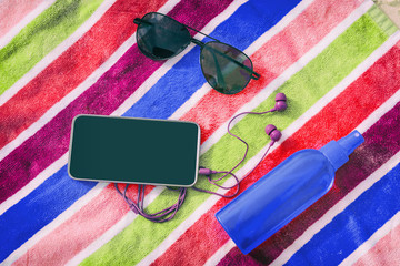 Beach accessories for summer travel holidays. Top view of black screen mobile phone for copy space,...