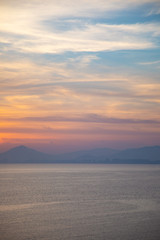 A peaceful scene of a calm ocean and gentle sunset