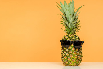 bright juicy pineapple in sunglasses