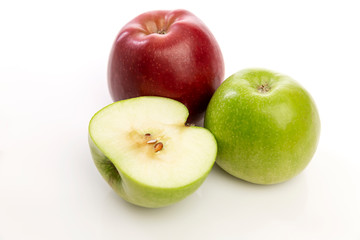 Red and green apples on a white background. Healthy and tasty vegetarian food.