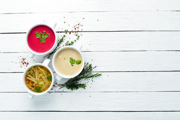 Set of soups. Meat soup, fish soup, chicken soup. Dishes, food. Top view. Free space for your text.