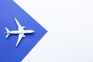 Airplane model on blue paper background