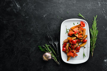 Baked potatoes with vegetables. Dishes, food. Top view. Free space for your text.