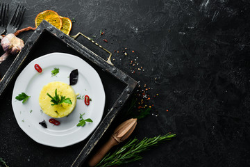 Mashed potatoes with onions on a plate. Dishes, food. Top view. Free space for your text.