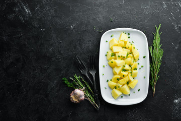 Boiled potatoes with onions on a plate. Dishes, food. Top view. Free space for your text.