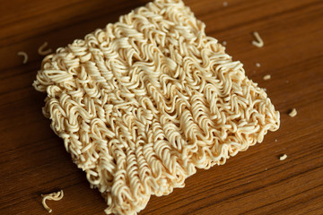 Uncooked instant noodle on wood table