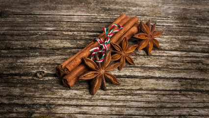 Star anise with cinnamon and nuts at christmas time over old wood background