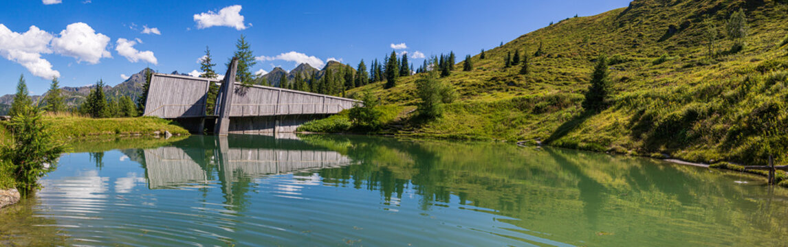 High resolution stitched panorama of a lake with reflections and a beautiful alpine view at Rauris, Salzburg, Austria © Martin Erdniss