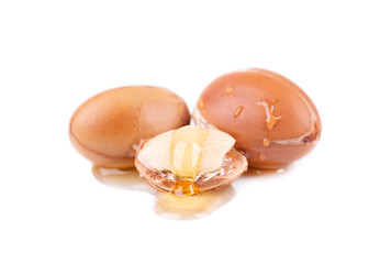 Argan seeds, isolated on a white background. Argan nuts and oil, for cosmetic and beauty products. Natural argan fruit from Morocco.