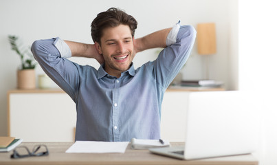 Successful Entrepreneur Relaxing Sitting At Laptop At Workplace