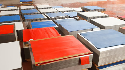 Sheet tin metal in production hall, marked with colored sheets