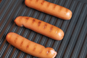 Barbecued pork sausages on an electric grill. BBQ.