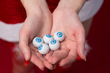 Many eyeballs with blue iris in the palms of the girl. Concept for halloween.