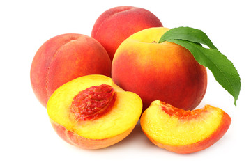 peach fruit with green leaves and slices isolated on white background