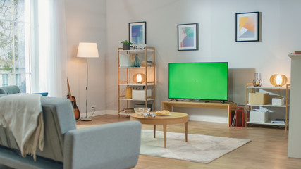 Cozy Living Room with Stylish Furniture and Design, Green Chroma Key TV in the Middle of the Room.