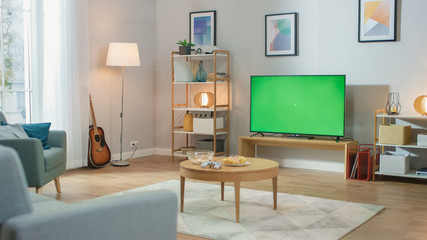 Cozy Living Room with Stylish Furniture and Design, Green Chroma Key TV in the Middle of the Room.