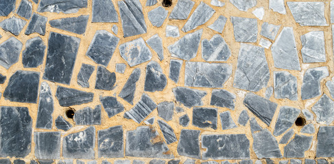 Background of grey blue stone wall.