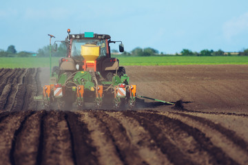Tractor and Seeder Planting Crops on a Field