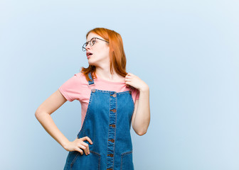 young red head pretty woman feeling stressed, anxious, tired and frustrated, pulling shirt neck,...