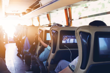 The passengers in the bus which are tourists and guide