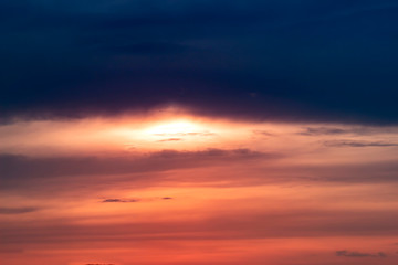 Fiery orange sunset sky. Beautiful sky with clouds.