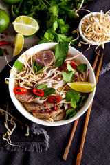 Pho Noodle Soup on dark table. Beef with Chilli, Basil, Rice Noodles, Bean Shoots showing noodles - 292978238