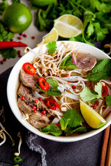 Pho Noodle Soup on dark table. Beef with Chilli, Basil, Rice Noodles, Bean Shoots showing noodles - 292978491
