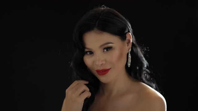 Cute Asian Lady With Makeup Smile And Tourch Her Hair.