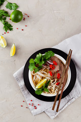 Vietnamese Pho Noodle Soup on light table. Beef with Chilli, Basil, Rice Noodles, Bean Shoots showing noodles - 292978619
