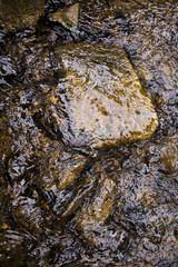 Top view of large stones under water flow