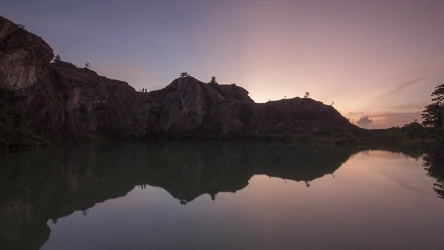 Timelapse sunset with perfect reflection of rock stone formation at Frog Hill, Penang.