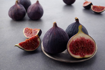 A few fresh figs in a bowl on an old dark background.