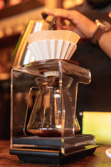 Barista in coffee shop preparing a cappuccino