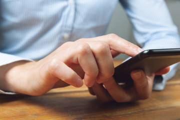 Woman's hands using mobile smartphone. Woman texting, doing business