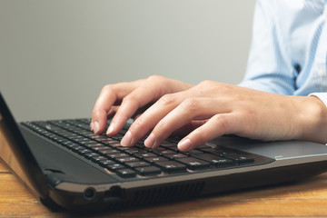Businesswoman's hands typing on laptop keybord. 